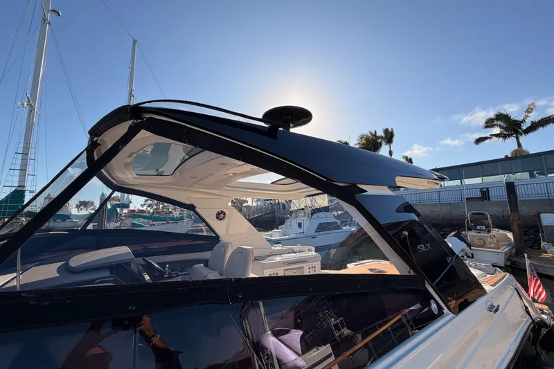 Slide: The Image of 2021 Sea Ray SLX 400 boat docked under clear blue sky. - 11