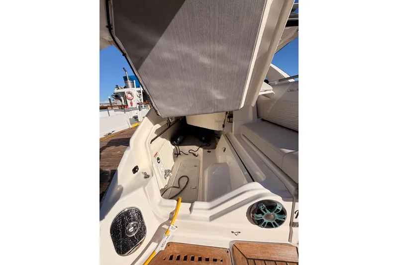 Slide: The Image of 2021 Sea Ray SLX 400 boat interior with open storage compartment and seating area. - 14