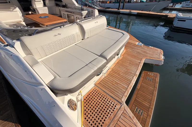 Slide: The Image of 2021 Sea Ray SLX 400 boat with spacious deck and luxurious seating at marina. - 15