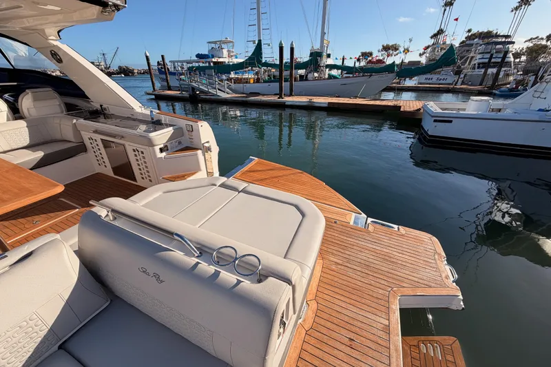 Slide: The Image of Luxurious 2021 Sea Ray SLX 400 yacht docked, showcasing elegant seating and teak deck. - 16