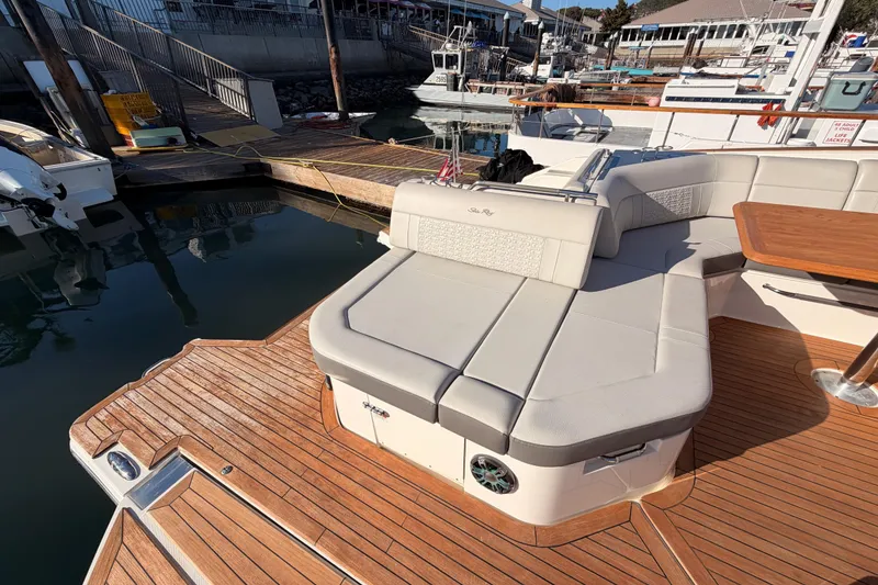 Slide: The Image of 2021 Sea Ray SLX 400 boat with luxurious seating and wooden deck at marina. - 18