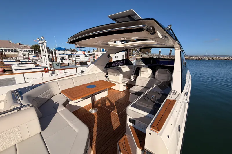 Slide: The Image of 2021 Sea Ray SLX 400 luxury boat with spacious seating and elegant design at a marina. - 19