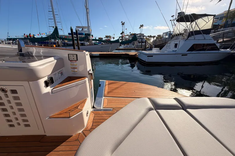Slide: The Image of 2021 Sea Ray SLX 400 yacht interior with wooden deck, docked at marina. - 21