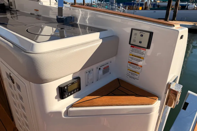 Slide: The Image of 2021 Sea Ray SLX 400 boat interior with control panel and wooden accents. - 23