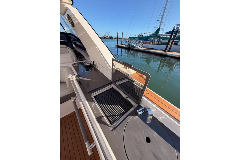 Slide: The Image of Outdoor grill on 2021 Sea Ray SLX 400 yacht, docked at marina. - 24