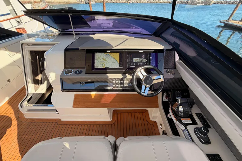 Slide: The Image of 2021 Sea Ray SLX 400 helm with advanced navigation system and luxurious interior design. - 27