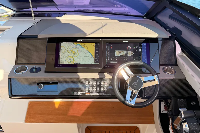 Slide: The Image of 2021 Sea Ray SLX 400 helm with advanced navigation system and sleek steering wheel. - 28