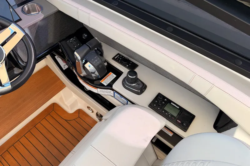 Slide: The Image of 2021 Sea Ray SLX 400 helm with steering wheel, controls, and navigation system. - 29