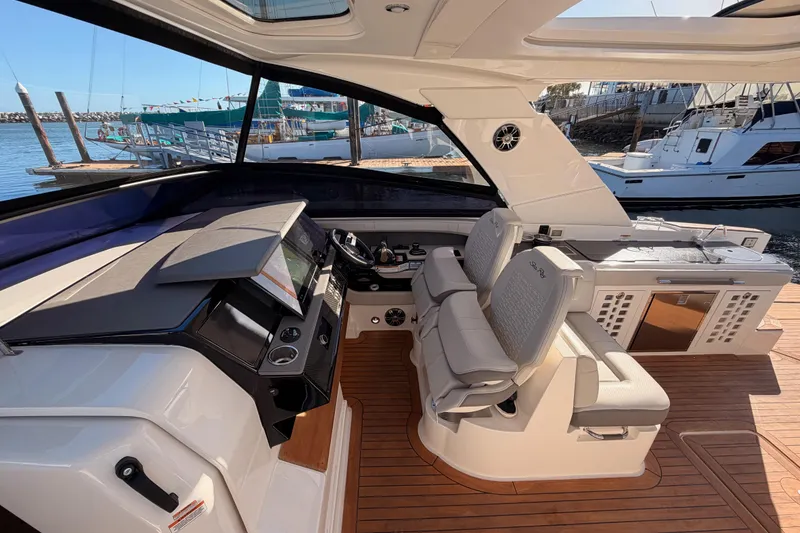 Slide: The Image of 2021 Sea Ray SLX 400 yacht cockpit with luxurious seating and modern controls. - 31