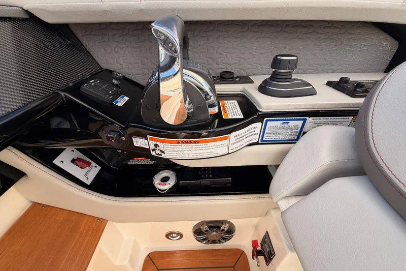 Slide: The Image of 2021 Sea Ray SLX 400 helm controls with joystick and throttle levers. - 33