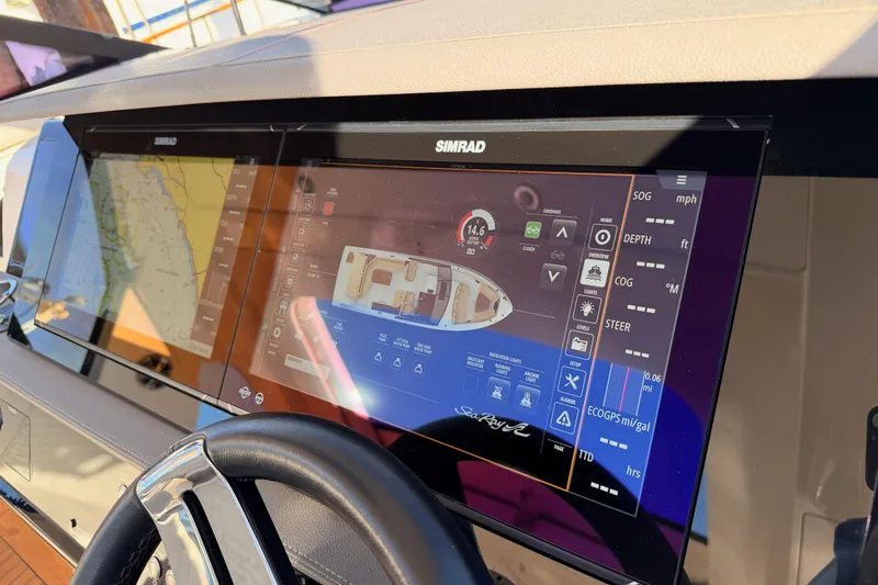 Slide: The Image of Dashboard of a 2021 Sea Ray SLX 400 boat with Simrad navigation display. - 35