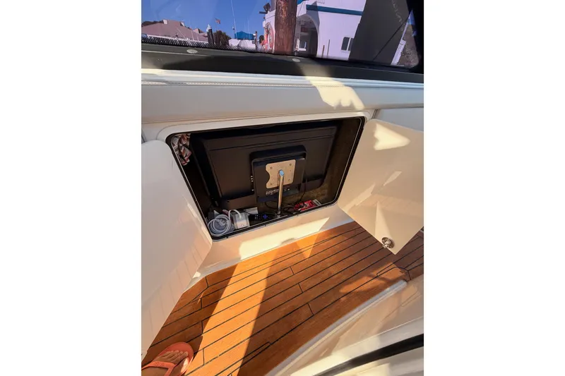 Slide: The Image of 2021 Sea Ray SLX 400 interior with open storage compartment and wooden flooring. - 39