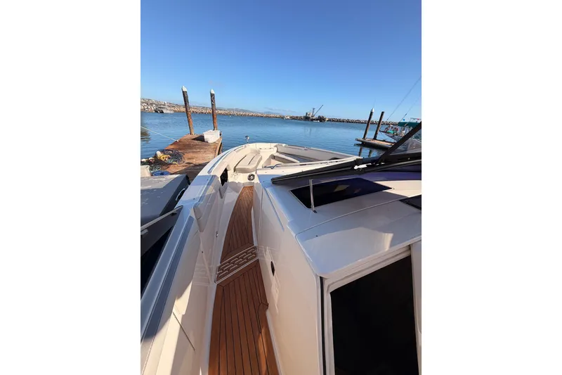 Slide: The Image of 2021 Sea Ray SLX 400 yacht docked at a marina with clear blue skies. - 40