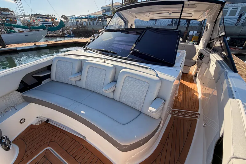 Slide: The Image of 2021 Sea Ray SLX 400 boat interior with luxurious seating and wooden deck. - 42