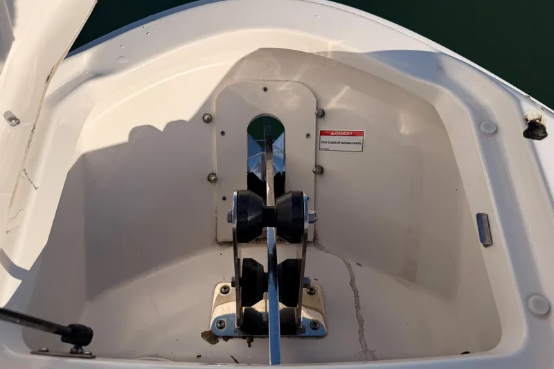Slide: The Image of Anchor compartment of 2021 Sea Ray SLX 400 boat, featuring safety warning label. - 46