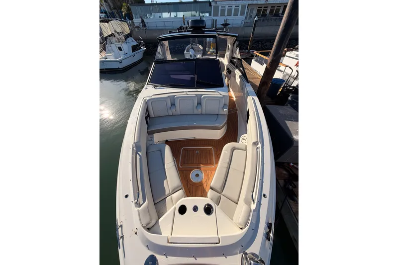 Slide: The Image of 2021 Sea Ray SLX 400 boat with spacious seating and elegant design at a marina. - 47