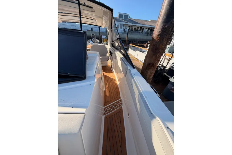 Slide: The Image of 2021 Sea Ray SLX 400 boat with teak deck, docked at marina. - 49
