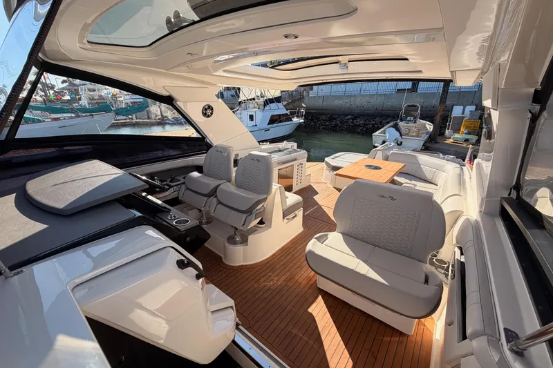 Slide: The Image of Luxurious 2021 Sea Ray SLX 400 boat interior with elegant seating and wooden flooring. - 50