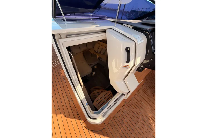 Slide: The Image of 2021 Sea Ray SLX 400 cabin entrance with teak flooring and cozy interior seating. - 51