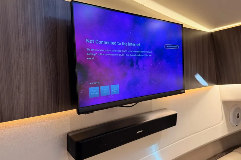 Slide: The Image of Flat-screen TV and soundbar in 2021 Sea Ray SLX 400 boat interior. - 56