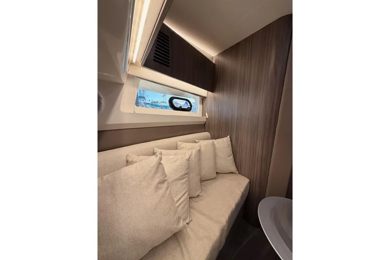 Slide: The Image of Interior of 2021 Sea Ray SLX 400 with cozy seating and window view. - 59