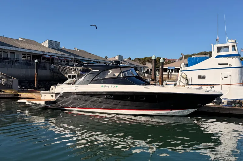 Slide: The Image of 2021 Sea Ray SLX 400 docked at marina, clear sky, calm water. - 6