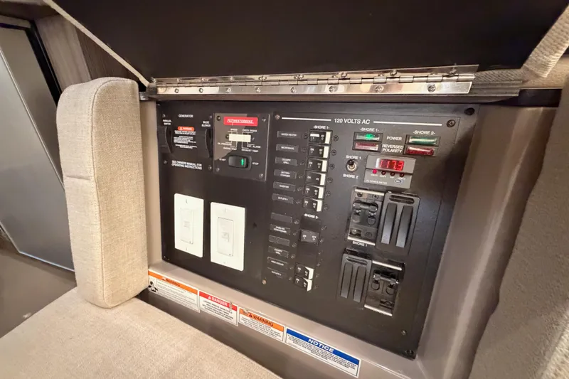 Slide: The Image of Electrical control panel on 2021 Sea Ray SLX 400 boat, featuring switches and indicators. - 62