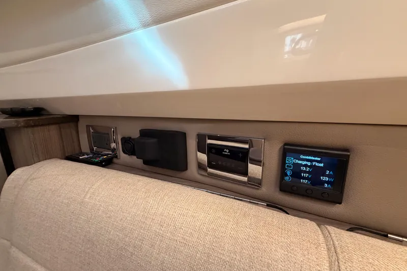 Slide: The Image of Interior control panel of 2021 Sea Ray SLX 400 boat, featuring electronic displays and controls. - 63