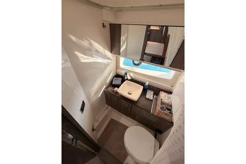 Slide: The Image of Luxurious bathroom in 2021 Sea Ray SLX 400 yacht with modern fixtures and window view. - 67