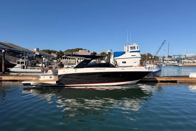 Slide: The Image of 2021 Sea Ray SLX 400 yacht docked at a marina under clear blue skies. - 7