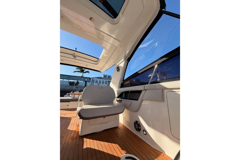 Slide: The Image of 2021 Sea Ray SLX 400 interior with seating and wooden flooring. - 71