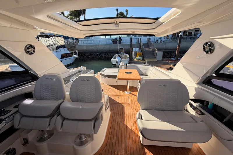 Slide: The Image of 2021 Sea Ray SLX 400 boat interior with luxurious seating and wooden deck. - 72