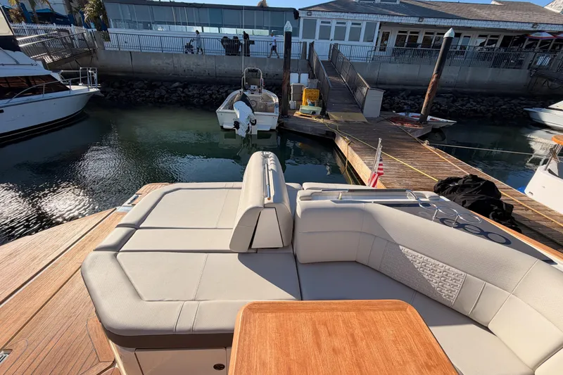 Slide: The Image of 2021 Sea Ray SLX 400 luxury boat with spacious seating at marina dock. - 75