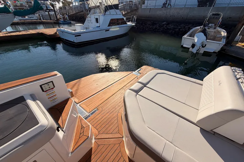 Slide: The Image of 2021 Sea Ray SLX 400 boat with teak deck and luxurious seating at marina. - 76