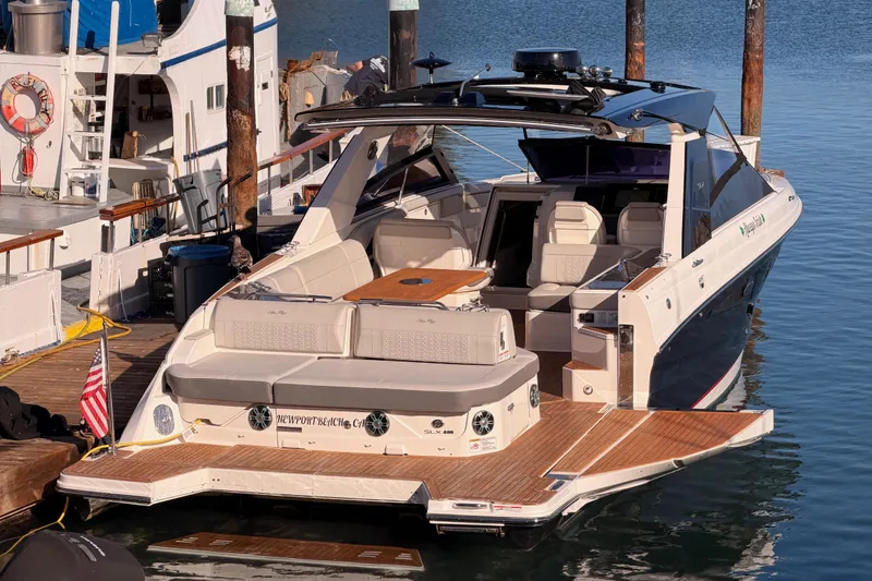 Slide: The Image of 2021 Sea Ray SLX 400 luxury boat docked at marina, featuring spacious seating and elegant design. - 8