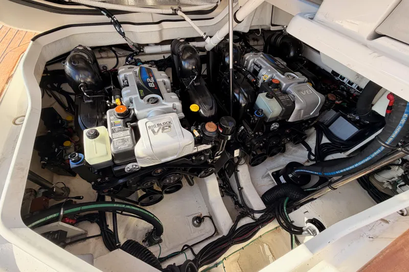 Slide: The Image of Engine compartment of 2021 Sea Ray SLX 400 with dual V8 engines, showcasing mechanical components. - 82