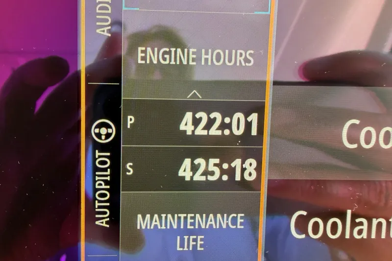 Slide: The Image of Dashboard display of a 2021 Sea Ray SLX 400 showing engine hours and maintenance life. - 83