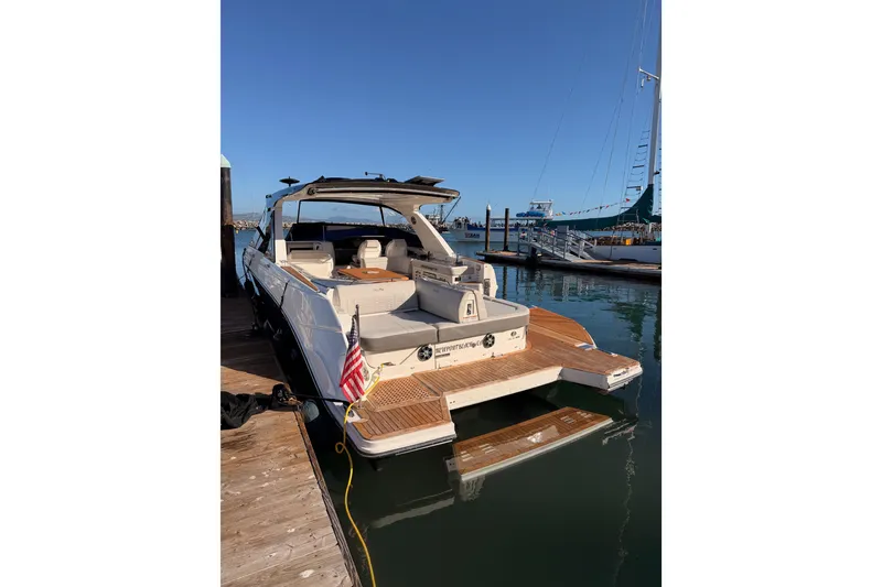 Slide: The Image of 2021 Sea Ray SLX 400 yacht docked at marina, showcasing spacious deck and elegant design. - 9