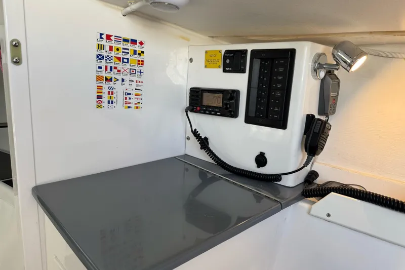 Slide: The Image of Interior of 2014 J Boats J/88 with navigation equipment and signal flag chart. - 21