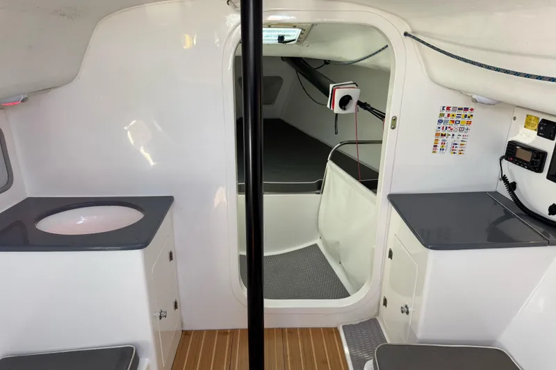 Slide: The Image of Interior of 2014 J Boats J/88 sailboat, featuring compact cabin with modern amenities. - 25