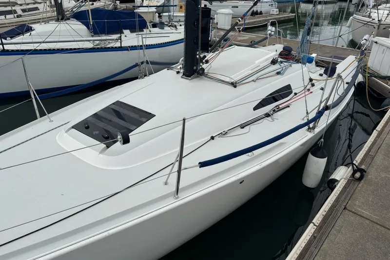 Slide: The Image of 2014 J Boats J/88 sailboat docked at a marina, showcasing sleek design and rigging. - 4