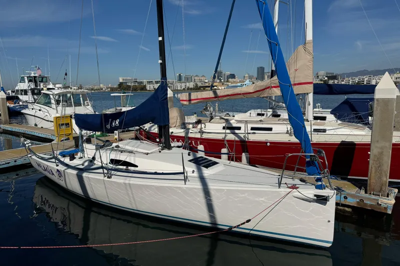 Slide: The Image of 2014 J Boats J/88 sailboat docked in marina under clear blue sky. - 6