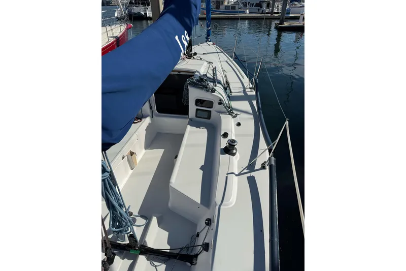 Slide: The Image of 2014 J Boats J/88 sailboat deck with blue sail cover, docked at marina. - 8