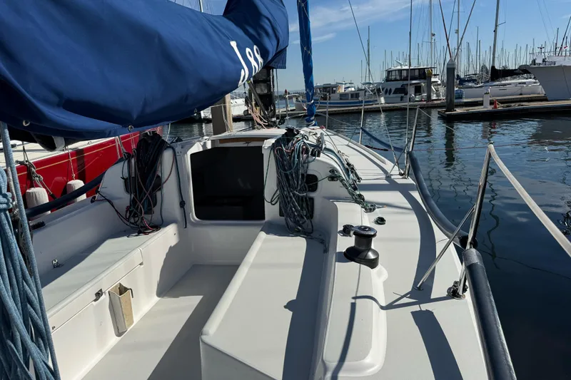 Slide: The Image of 2014 J Boats J/88 sailboat docked in a marina, featuring a clean deck and rigging. - 9