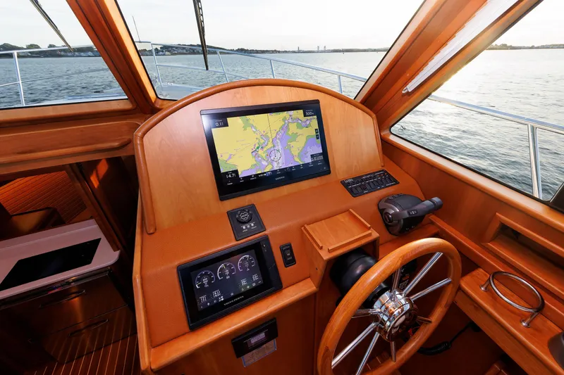 Slide: The Image of Helm of 2022 Sabre 38 SE yacht with navigation screens and wooden finish. - 17