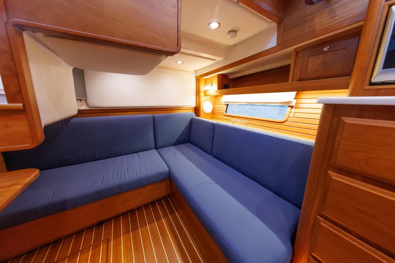 Slide: The Image of Interior of 2022 Sabre 38 SE yacht with blue seating and wooden finishes. - 23