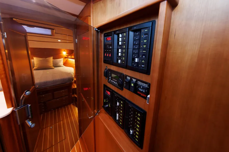 Slide: The Image of 2022 Sabre 38 SE yacht interior with control panel and cozy bedroom. - 24