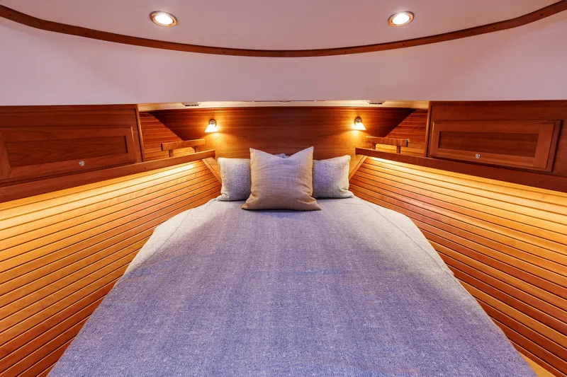 Slide: The Image of Luxurious cabin interior of 2022 Sabre 38 SE yacht with cozy bedding and warm lighting. - 27