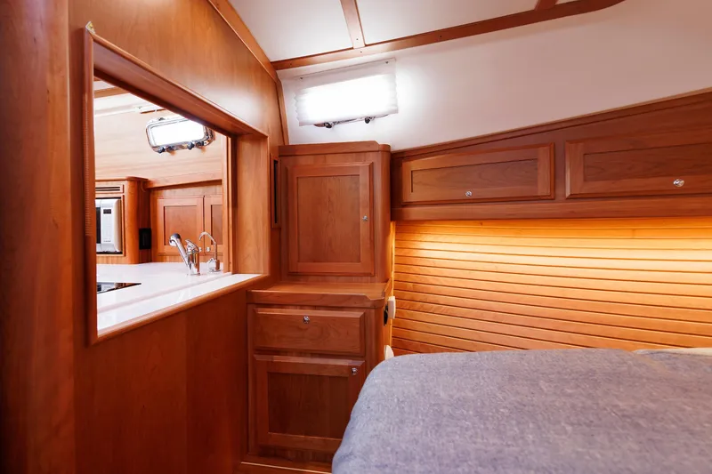 Slide: The Image of Interior of 2022 Sabre 38 SE yacht, featuring elegant wood cabinetry and modern fixtures. - 28