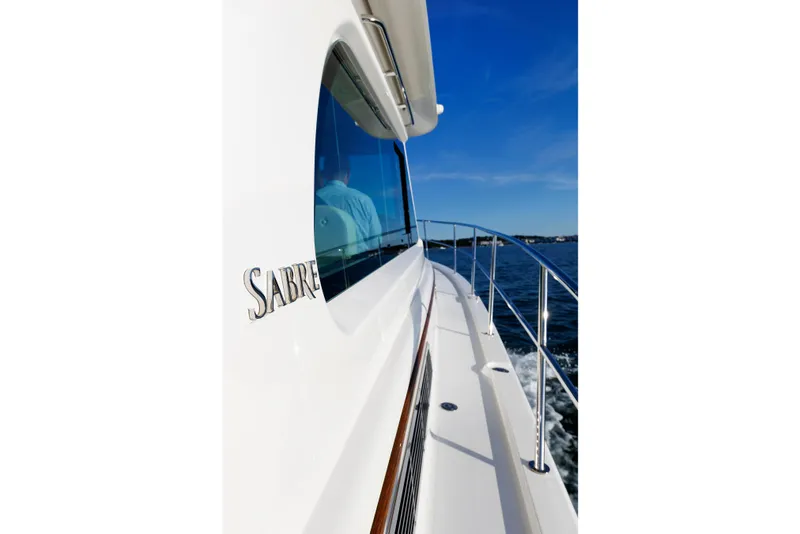 Slide: The Image of 2022 Sabre 38 SE yacht cruising on open water under clear blue skies. - 40